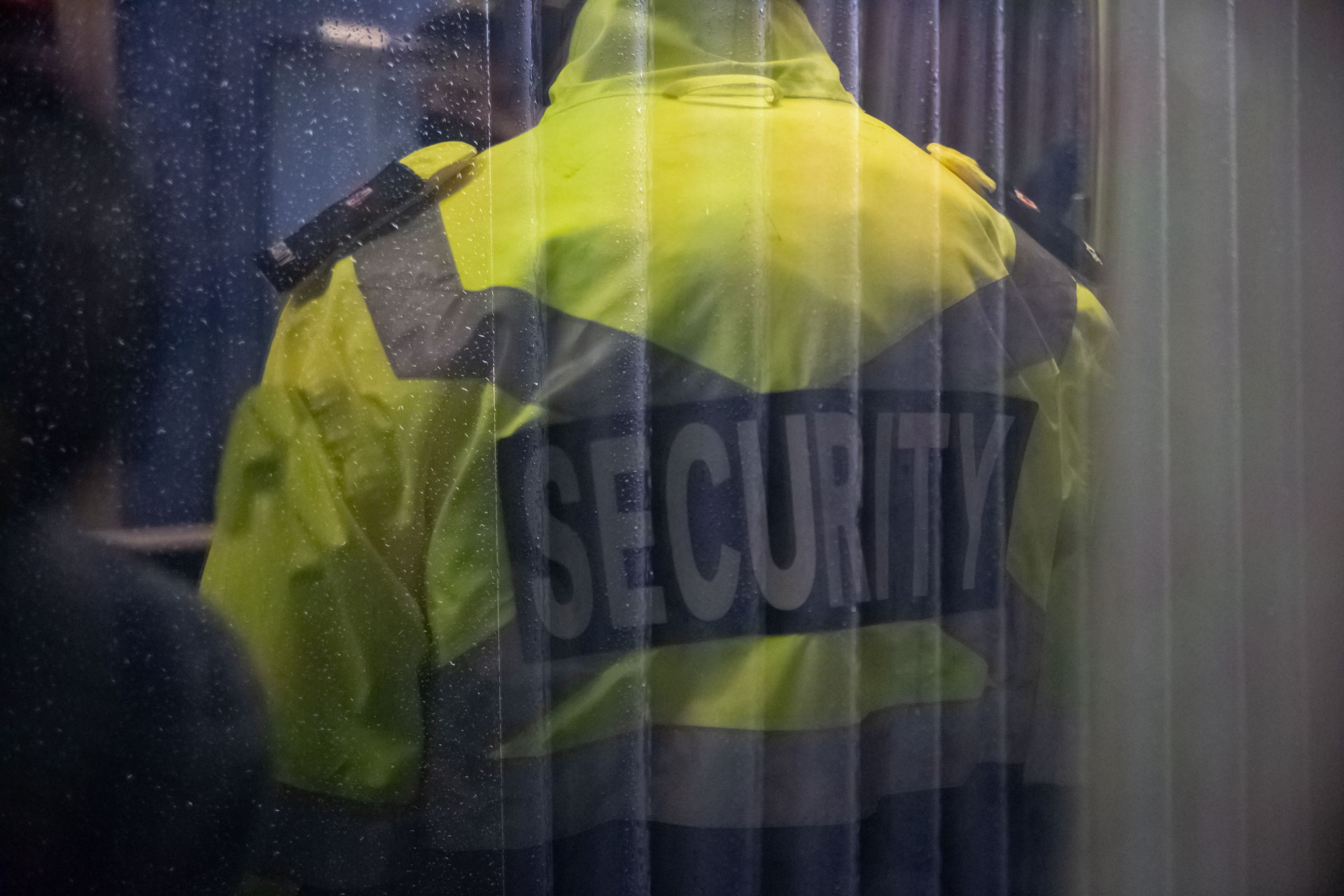 Security guard standing inside commercial building nearby the wi